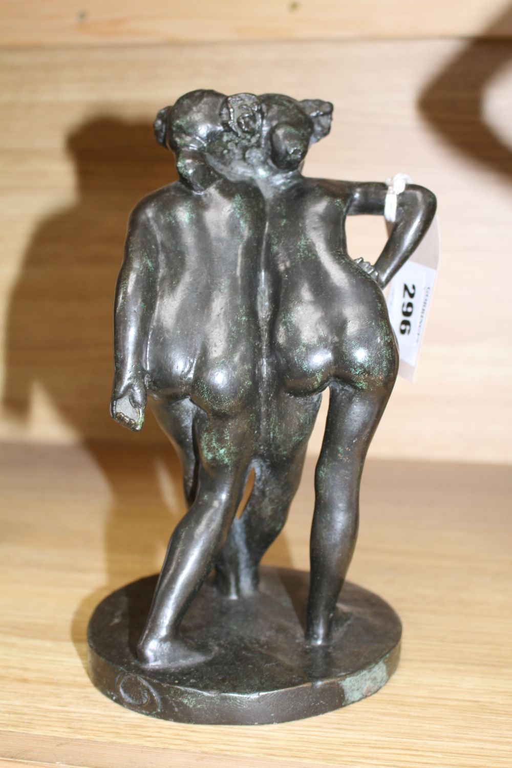 After Pierre-Auguste Renoir. A French lost wax bronze group of embracing maidens H.9in.